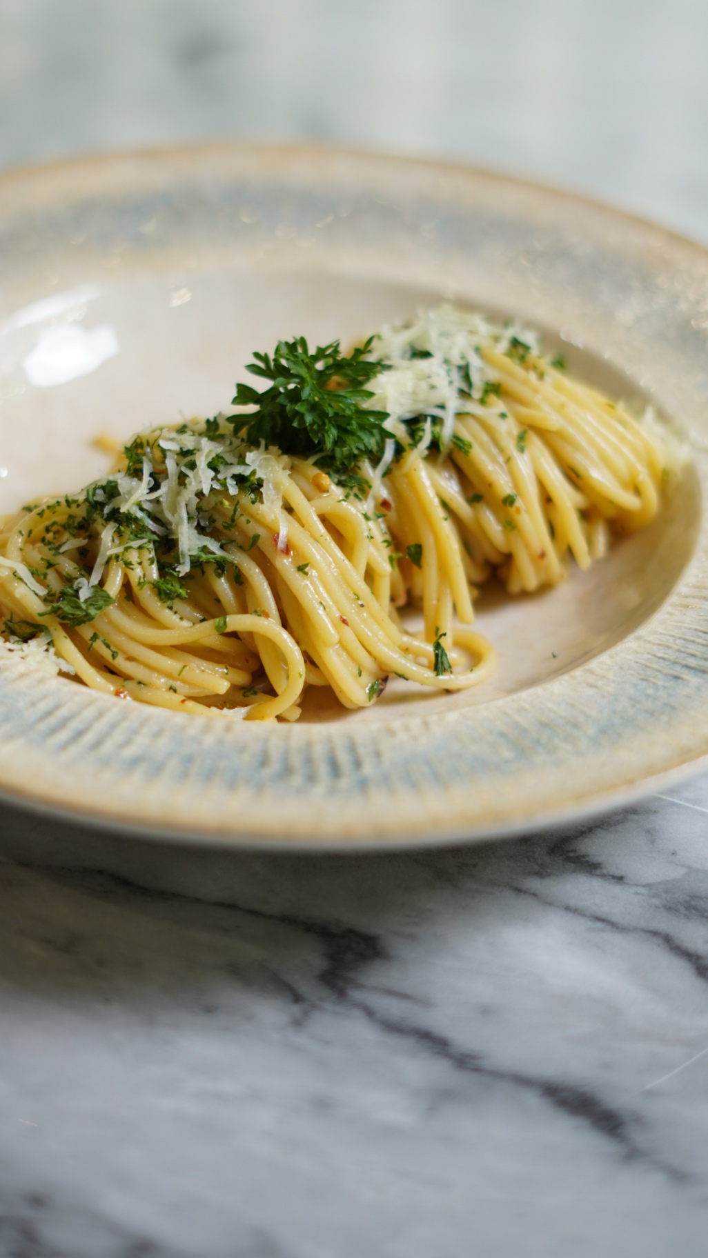 Spaghetti aglio e olio with parsley, chili flakes and grated parmesan