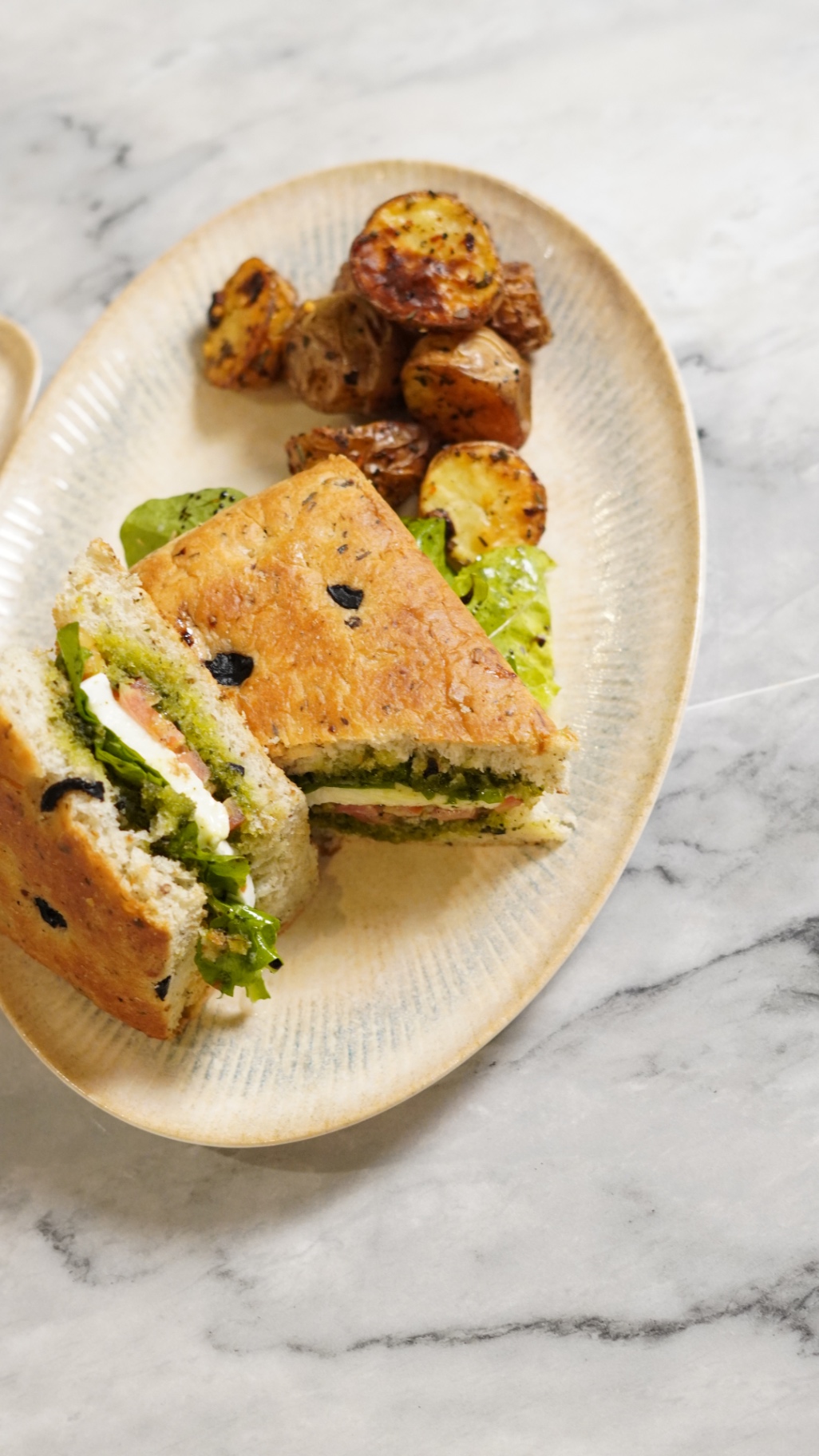 Focaccia panuzo with mozzarella and rocket, served with herbed baby potatoes